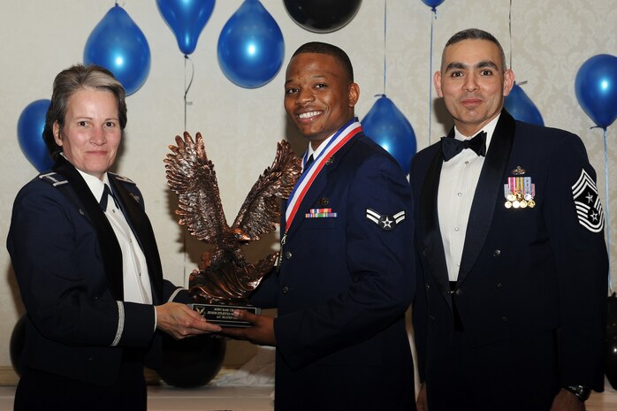 Col. Martha Meeker, left, and Chief Master Sgt. Jose LugoSantiago, right, presents Airman 1st Class Deaven Gathers with the Airman of the Year award for 2010 during the annual awards banquet held at the Charleston Club Jan 20, 2010. Airmen, Sailors and civilians were presented with an award for their outstanding accomplishments from one of the 15 different categories recognized. Unable to attend the banquet due to deployment or other reasons was, from the 628th Mission Support Group, Noncommissioned Officer of the Year Staff Sgt. Akeem Parks; from the 628 MSG, Senior Noncommissioned Officer of the Year Master Sgt. Michael Patterson; from the 628 MSG, First Sergeant of the Year Master Sgt. Steven Hart; and from the Naval Weapons Station, Sailor of the Year Personnel Specialist 1st  Class Petty Officer James Long. Colonel Meeker is the Joint Base Charleston commander, Chief LugoSantiago is the 628th Air Base Wing command chief and Airman Gathers is from the 628 MSG. (U.S. Air Force photo/Tech. Sgt. Chrissy Best)