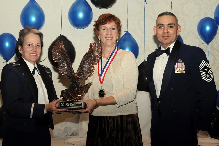 Col. Martha Meeker, left, and Chief Master Sgt. Jose LugoSantiago, right, presents Ms. Kathleen Edenborough with the Civilian of the Year category III award for 2010 during the annual awards banquet held at the Charleston Club Jan 20, 2010. Airmen, Sailors and civilians were presented with an award for their outstanding accomplishments from one of the 15 different categories recognized. Unable to attend the banquet due to deployment or other reasons was, from the 628th Mission Support Group, Noncommissioned Officer of the Year Staff Sgt. Akeem Parks; from the 628 MSG, Senior Noncommissioned Officer of the Year Master Sgt. Michael Patterson; from the 628 MSG, First Sergeant of the Year Master Sgt. Steven Hart; and from the Naval Weapons Station, Sailor of the Year Personnel Specialist 1st  Class Petty Officer James Long. Colonel Meeker is the Joint Base Charleston commander, Chief LugoSantiago is the 628th Air Base Wing command chief and Ms. Edenborough is from the 628 MSG. (U.S. Air Force photo/Tech. Sgt. Chrissy Best)