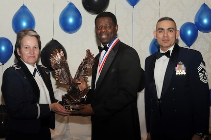 Col. Martha Meeker, left, and Chief Master Sgt. Jose LugoSantiago, right, presents Mr. Alvin Green with the Civilian of the Year category II award for 2010 during the annual awards banquet held at the Charleston Club Jan 20, 2010. Airmen, Sailors and civilians were presented with an award for their outstanding accomplishments from one of the 15 different categories recognized. Unable to attend the banquet due to deployment or other reasons was, from the 628th Mission Support Group, Noncommissioned Officer of the Year Staff Sgt. Akeem Parks; from the 628 MSG, Senior Noncommissioned Officer of the Year Master Sgt. Michael Patterson; from the 628 MSG, First Sergeant of the Year Master Sgt. Steven Hart; and from the Naval Weapons Station, Sailor of the Year Personnel Specialist 1st  Class Petty Officer James Long. Colonel Meeker is the Joint Base Charleston commander, Chief LugoSantiago is the 628th Air Base Wing command chief and Mr. Green is from the 628 MSG. (U.S. Air Force photo/Tech. Sgt. Chrissy Best)