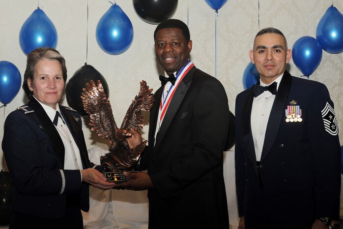 Col. Martha Meeker, left, and Chief Master Sgt. Jose LugoSantiago, right, presents Mr. Alvin Green with the Civilian of the Year category II award for 2010 during the annual awards banquet held at the Charleston Club Jan 20, 2010. Airmen, Sailors and civilians were presented with an award for their outstanding accomplishments from one of the 15 different categories recognized. Unable to attend the banquet due to deployment or other reasons was, from the 628th Mission Support Group, Noncommissioned Officer of the Year Staff Sgt. Akeem Parks; from the 628 MSG, Senior Noncommissioned Officer of the Year Master Sgt. Michael Patterson; from the 628 MSG, First Sergeant of the Year Master Sgt. Steven Hart; and from the Naval Weapons Station, Sailor of the Year Personnel Specialist 1st  Class Petty Officer James Long. Colonel Meeker is the Joint Base Charleston commander, Chief LugoSantiago is the 628th Air Base Wing command chief and Mr. Green is from the 628 MSG. (U.S. Air Force photo/Tech. Sgt. Chrissy Best)