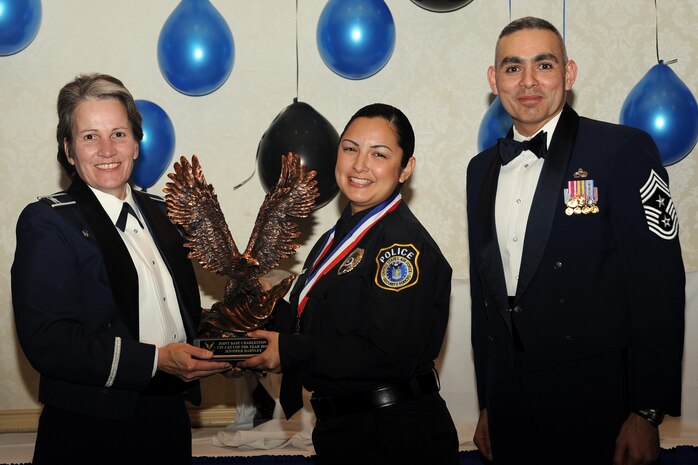 Col. Martha Meeker, left, and Chief Master Sgt. Jose LugoSantiago, right, presents Ms. Jennifer Hartley with the Civilian of the Year category I award for 2010 during the annual awards banquet held at the Charleston Club Jan 20, 2010. Airmen, Sailors and civilians were presented with an award for their outstanding accomplishments from one of the 15 different categories recognized. Unable to attend the banquet due to deployment or other reasons was, from the 628th Mission Support Group, Noncommissioned Officer of the Year Staff Sgt. Akeem Parks; from the 628 MSG, Senior Noncommissioned Officer of the Year Master Sgt. Michael Patterson; from the 628 MSG, First Sergeant of the Year Master Sgt. Steven Hart; and from the Naval Weapons Station, Sailor of the Year Personnel Specialist 1st  Class Petty Officer James Long. Colonel Meeker is the Joint Base Charleston commander, Chief LugoSantiago is the 628th Air Base Wing command chief and Ms. Hartley is from the 628 MSG. (U.S. Air Force photo/Tech. Sgt. Chrissy Best)