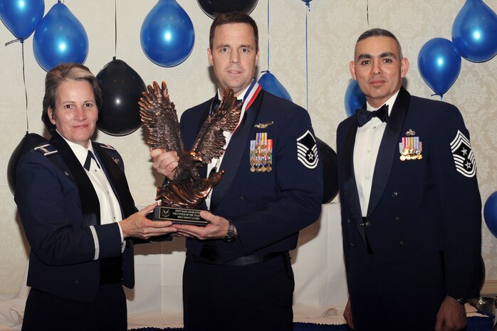 Col. Martha Meeker, left, and Chief Master Sgt. Jose LugoSantiago, right, presents Master Sgt. Donny Leydig with the Volunteer of the year award for 2010 during the annual awards banquet held at the Charleston Club Jan 20, 2010. Airmen, Sailors and civilians were presented with an award for their outstanding accomplishments from one of the 15 different categories recognized. Unable to attend the banquet due to deployment or other reasons was, from the 628th Mission Support Group, Noncommissioned Officer of the Year Staff Sgt. Akeem Parks; from the 628 MSG, Senior Noncommissioned Officer of the Year Master Sgt. Michael Patterson; from the 628 MSG, First Sergeant of the Year Master Sgt. Steven Hart; and from the Naval Weapons Station, Sailor of the Year Personnel Specialist 1st  Class Petty Officer James Long. Colonel Meeker is the Joint Base Charleston commander, Chief LugoSantiago is the 628th Air Base Wing command chief and Sergeant Leydig is from the 628th Force Support Squadron. (U.S. Air Force photo/Tech. Sgt. Chrissy Best)