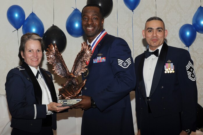 Col. Martha Meeker, left, and Chief Master Sgt. Jose LugoSantiago, right, presents Staff Sgt. Joseph Truesdale with the Honor Guard Member of the Year award for 2010 during the annual awards banquet held at the Charleston Club Jan 20, 2010. Airmen, Sailors and civilians were presented with an award for their outstanding accomplishments from one of the 15 different categories recognized. Unable to attend the banquet due to deployment or other reasons was, from the 628th Mission Support Group, Noncommissioned Officer of the Year Staff Sgt. Akeem Parks; from the 628 MSG, Senior Noncommissioned Officer of the Year Master Sgt. Michael Patterson; from the 628 MSG, First Sergeant of the Year Master Sgt. Steven Hart; and from the Naval Weapons Station, Sailor of the Year Personnel Specialist 1st  Class Petty Officer James Long. Colonel Meeker is the Joint Base Charleston commander, Chief LugoSantiago is the 628th Air Base Wing command chief and Sergeant Truesdale is from the 437th Operations Support Squadron. (U.S. Air Force photo/Tech. Sgt. Chrissy Best)