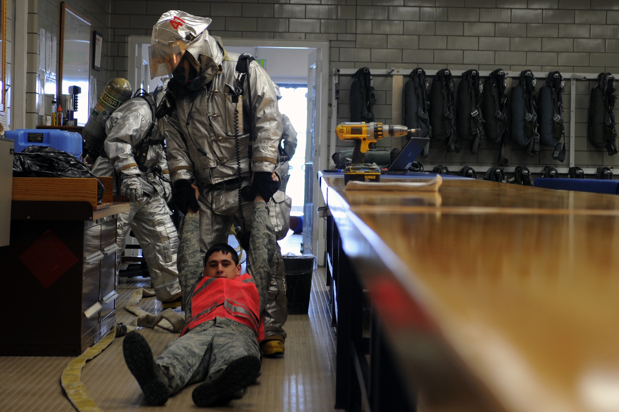 MINOT AIR FORCE BASE, N.D. -- Firefighters from the 5th Civil Engineer Squadron practice rescuing procedures on Airman Daniel Farmer, 5th Operation Support Squadron aircrew flight equipment technician, while responding to a simulated fire during a monthly structural drill here Jan. 24. Firefighters participate in the monthly drills to maintain excellence in their skills. (U.S. Air Force photo/Airman 1st Class Aaron-Forrest Wainwright)

