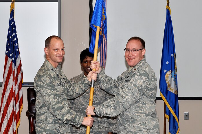 Col. James Clavenna passes the 437th Maintenance Operations Squadron guideon to Maj. Jason Engle during the 437 MOS change of command ceremony Jan. 13, 2010. Command of the squadron was relinquished from Maj. Patrick Lowe, who is joining the reserves. Major Engle is the prior operations officer for the 437th Aerial Port Squadron. Colonel Clavenna is the 437th Maintenance Group commander.
