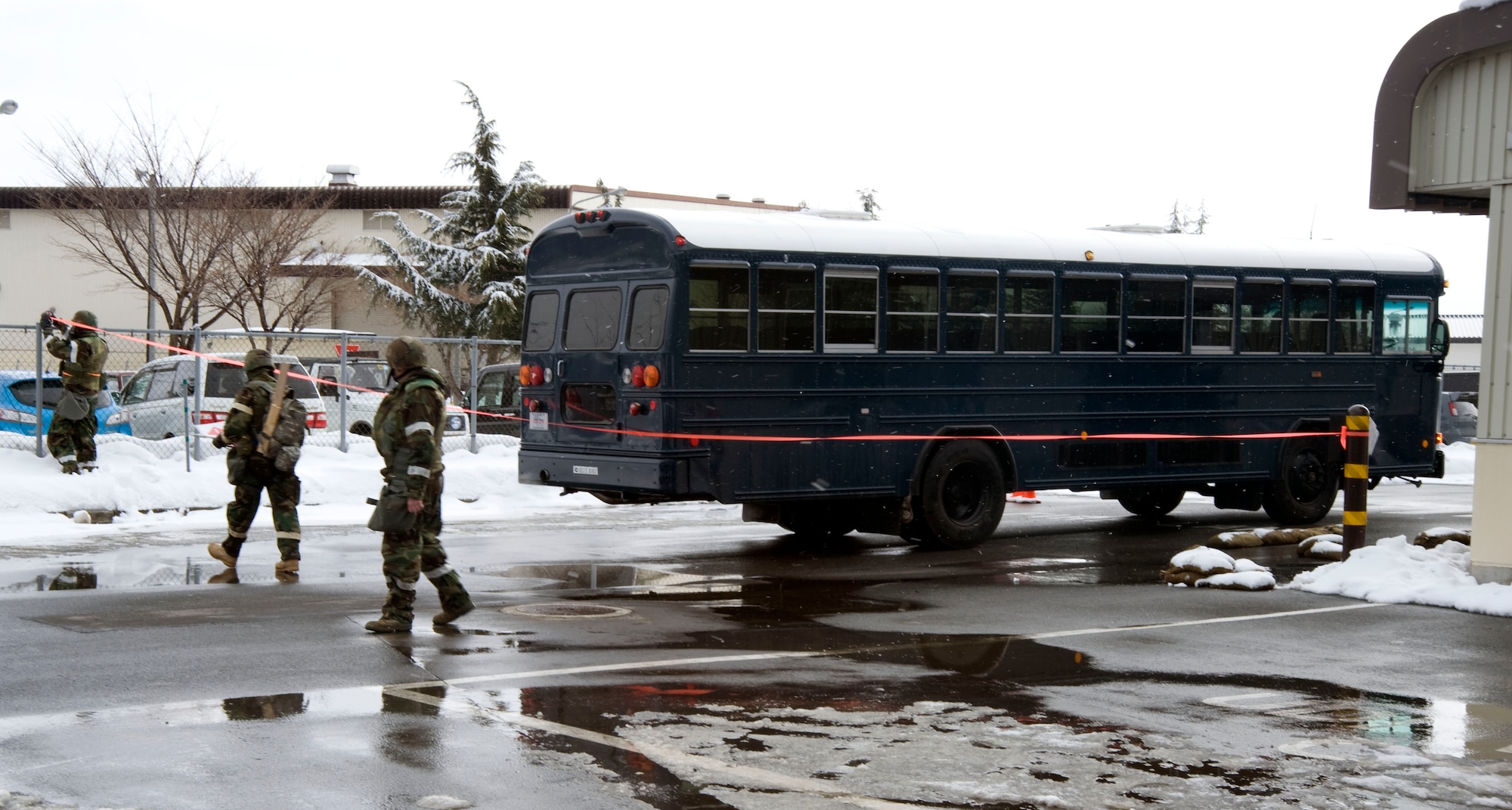 U.S. Air Force Airmen, from the 35th Logistics Readiness Squadron Vehicle Operations Flight, cordon off an area surrounding a (simulated) unexploded ordinance to keep people from getting hurt if it explodes Jan. 26, 2011, Misawa Air Base, Japan, The cordon sizes vary with the type of UXO found. (U.S. Air Force photo by Tech. Sgt. Russell McBride/Released)