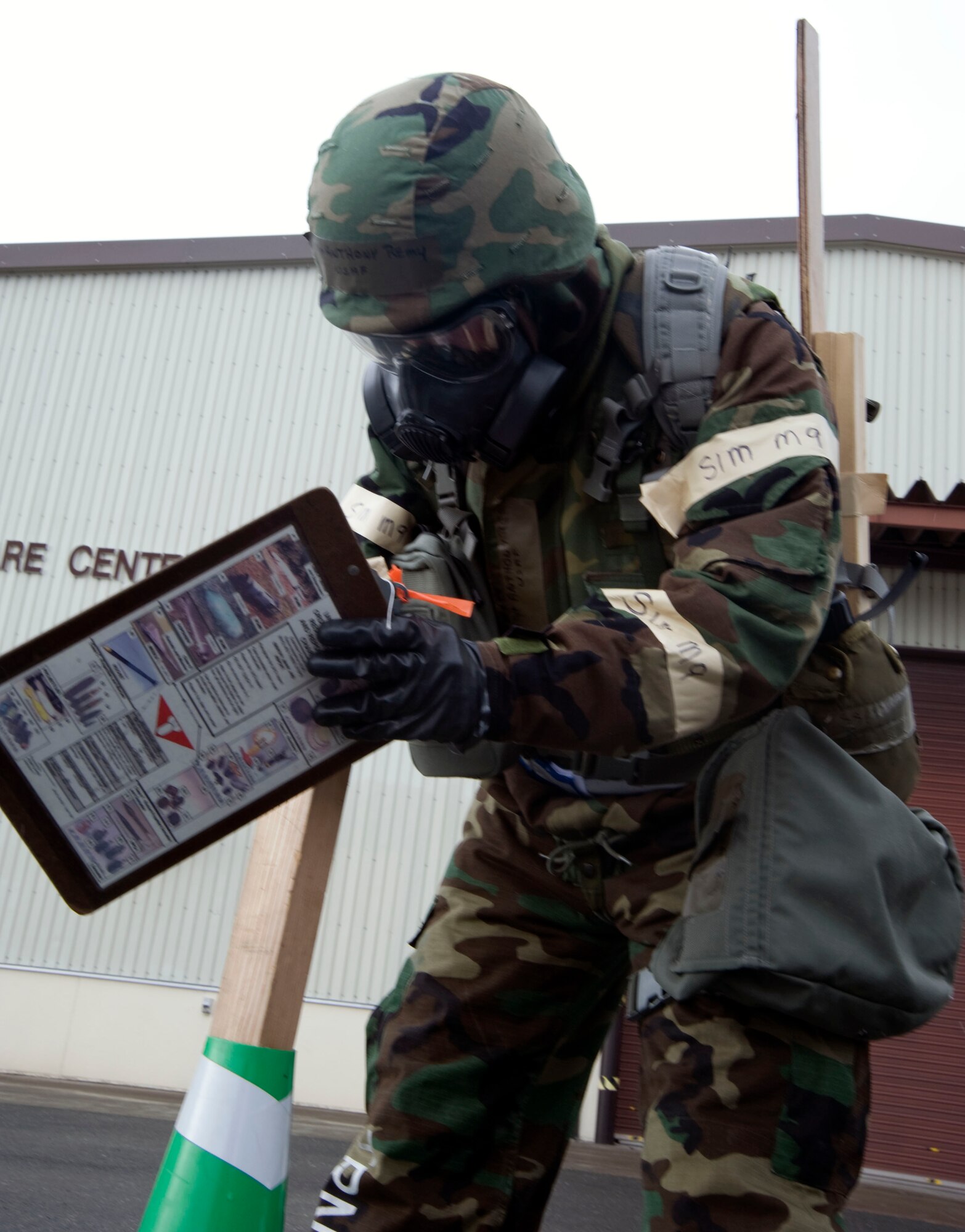 U.S. Air Force Staff Sgt. Anthony Remy, 35th Logistics Readiness Squadron vehicle operations technician, writes down the time and date he checks the (simulated) M8 paper on a chemical detection stanchion Jan. 26, 2011, Misawa Air Base, Japan. These checks are recorded after each attack to ensure accuracy in reporting information to leadership.  (U.S. Air Force photo by Tech. Sgt. Russell McBride/Released)