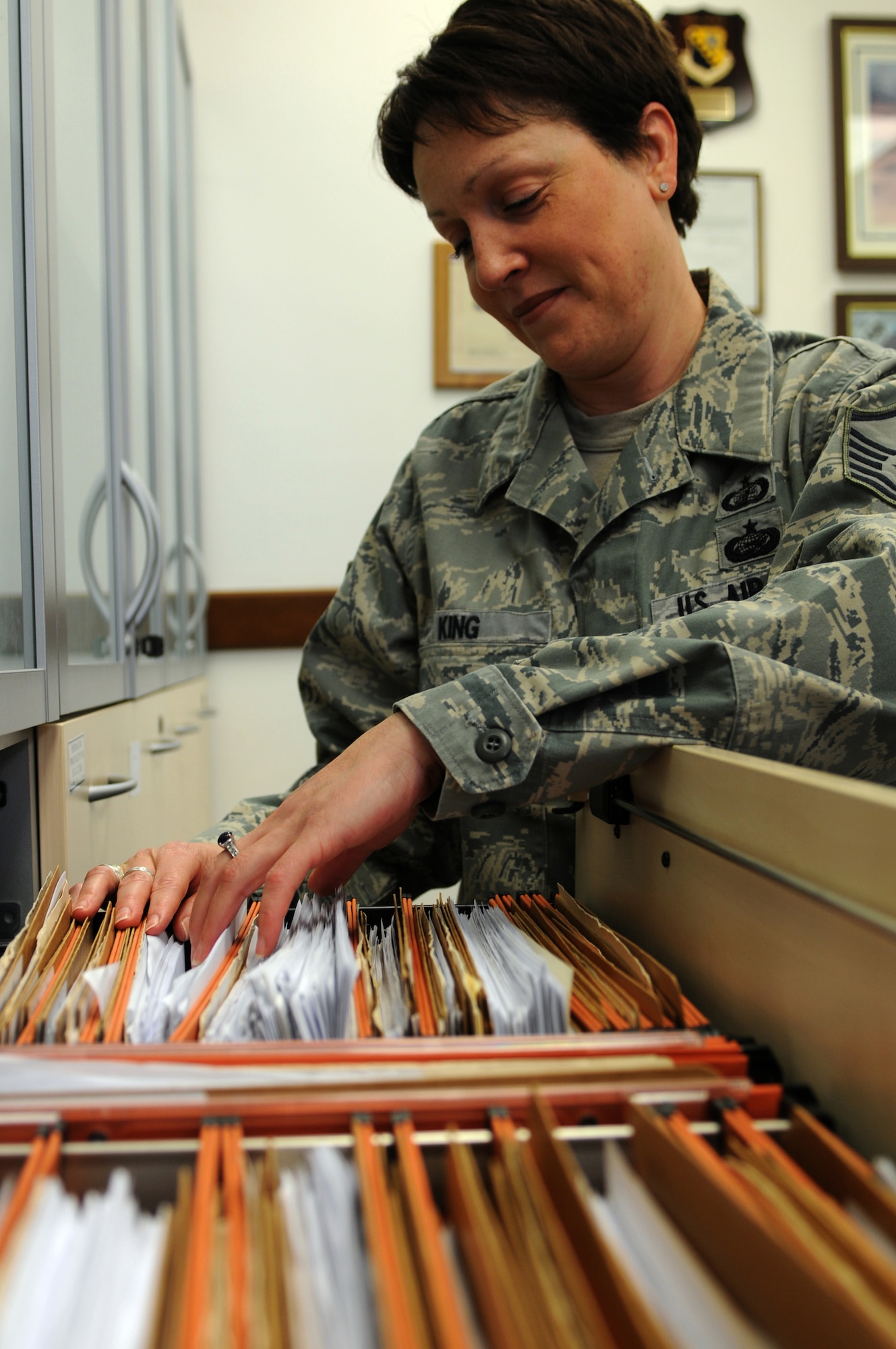Master Sgt. Michele King, 31st Contracting Squadron superintendent, sorts through a file cabinet Jan. 26. Sergeant King recently received the U.S. Air Forces in Europe Professional Courage in Contracting Award. (U.S. Air Force photo/Staff Sgt. Julius Delos Reyes)