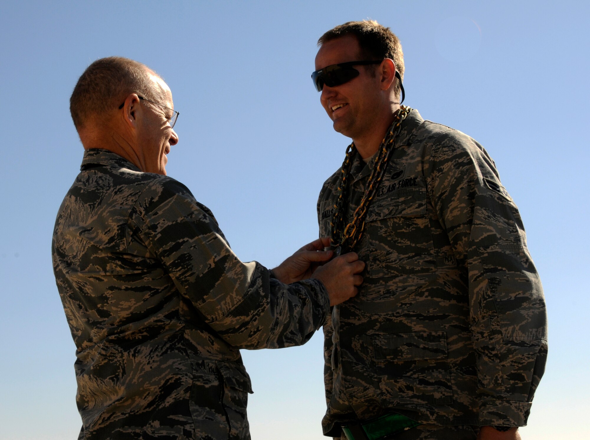 Col. Ricky Thompson, 386th Expeditionary Maintenance Group commander, places a first-place medal around the neck of Airman 1st Class Scott Halls, 386th EAMXS crew chief during the Maintenance Olympics, Jan. 22, at an undisclosed air base in Southwest Asia. Airman Halls won the chock toss with a hurl of 36'2 and also took first place in the wrench toss/toolbox build/100-yard dash relay event with a time of 1:39. Airman Halls' performance helped the 386th EAMXS defeat the Expeditionary Maintenance Squadron to claim the overall title. (U.S. Air Force photo by Capt. Heath Allen)