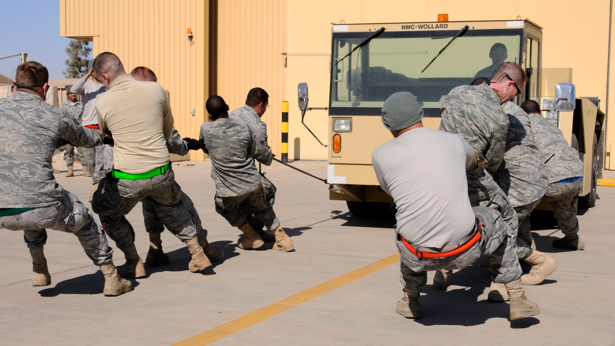 Members of the 386th Expeditionary Aircraft Maintenance Squadron compete in the tow vehicle pull, the final event of the Maintenance Olympics, Jan. 22, at an undisclosed air base in Southwest Asia. The 386th EAMXS won the event with a time of 11.68 seconds and defeated the 386th Expeditionary Maintenance Squadron to claim the overall title. (U.S. Air Force photo by Capt. Heath Allen)