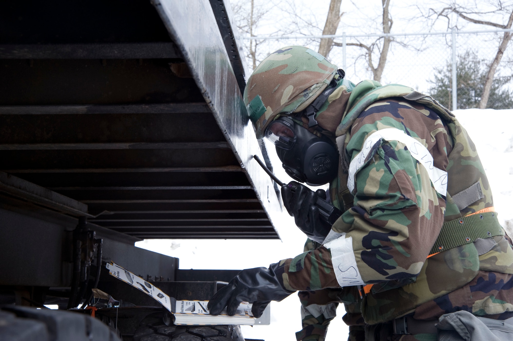 U.S Air Force Staff Sgt. David Montejano, 35th Logistics Readiness Squadron vehicle operations technician, calls his unit control center to report finding a (simulated) unexploded ordinance during a post attack reconnaissance sweep Jan. 26. 2011, Misawa Air Base, Japan. PAR sweeps are used to search the areas around buildings and equipment after an attack, to ensure the safety of people working in and around the buildings. (U.S. Air Force photo by Tech. Sgt. Russell McBride/Released)