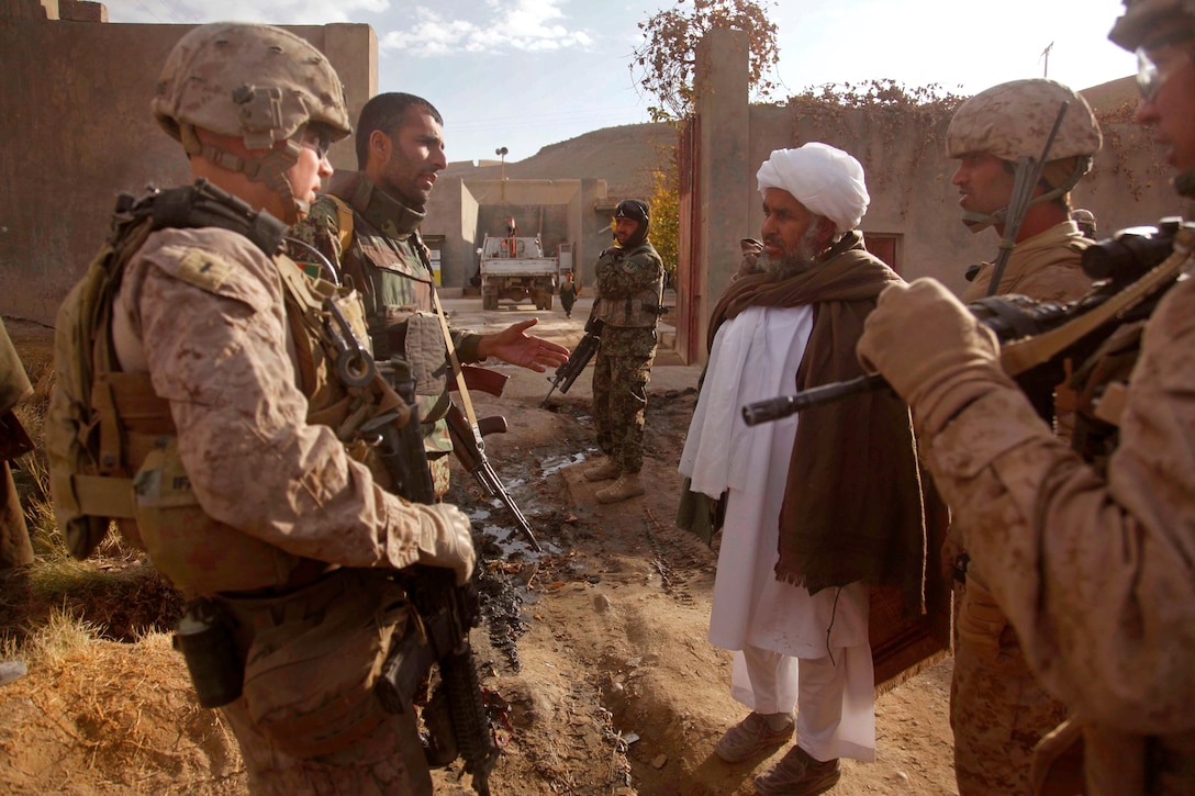 U.S. Marine Corps 1st Lt. Martin Lindig and Afghan soldiers speak to village elders during a census patrol in the Sangin district of Helmand province, Afghanistan, Jan. 17, 2011. Lindig is assigned to Lima Company, 3rd Battalion, 5th Marine Regiment, Regimental Combat Team 2.