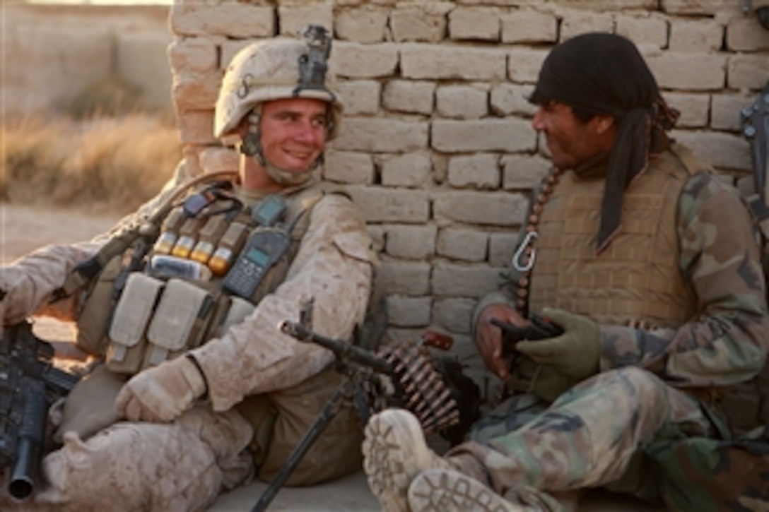 U.S. Marine Corps Lance Cpl. Brian Hinkle (left), with Echo Company, 2nd Battalion, 1st Marine Regiment, Regimental Combat Team 1, jokes with an Afghan National Army soldier during Operation Godfather in Durzay, Afghanistan, on Jan. 15, 2011.  The Marines partnered with the Afghan National Army to successfully clear the last remaining Taliban stronghold in the southern area of the Garmsir district.  The Marines were deployed to the Helmand province in support of the International Security Assistance Force.  