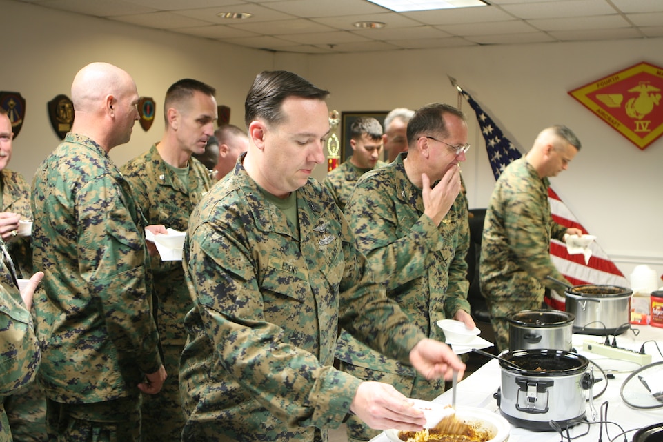 Marines of the 4th Marine Aircraft Wing line up to get their fill of the various selection of chili at the 4th MAW Second Annual Chili Cook-Off, Jan. 26.