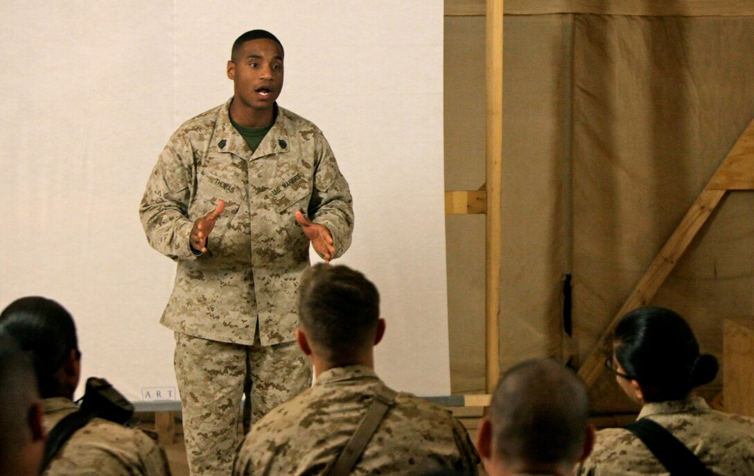 Gunnery Sgt. Clarence Thomas, course director, Combat Logistics Battalion 3, 1st Marine Logistics Group (Forward), speaks to junior Marines during the Lance Corporals Seminar graduation ceremony at Camp Dwyer, Afghanistan, Jan. 26. The 3-day seminar aimed to teach the junior Marines the fundamentals of Marine Corps leadership in preparation for when they become noncommissioned officers.