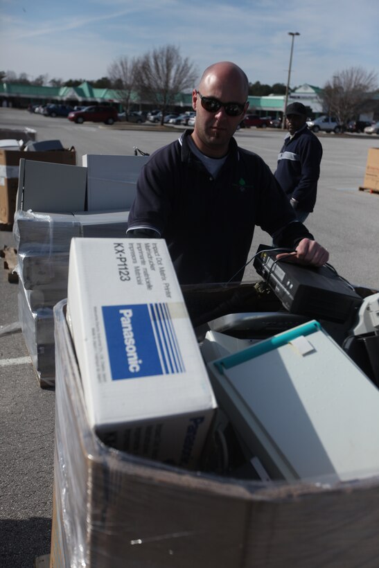 A base employee puts a box full of electronic equipment into a bin during this year’s first Electronics Recycling Event aboard Marine Corps Base Camp Lejeune, Jan. 27. Base personnel dropped off their used electronic equipment which many times is improperly discarded and can allow for chemicals to seep into the environment.