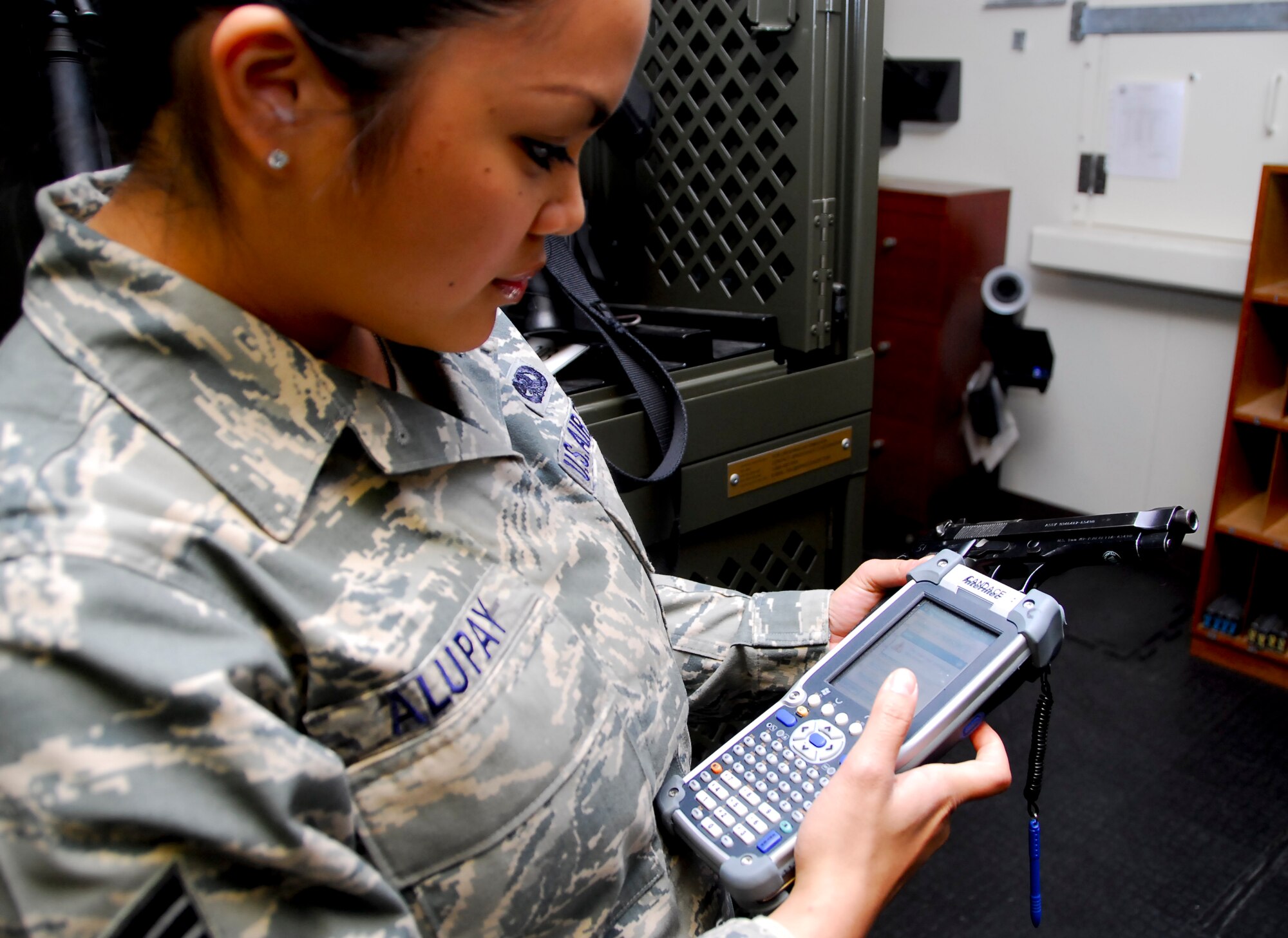 Senior Airman Sherylann Alupay, 18th Logistic Readiness Squadron, scans the two-dimensional barcode matrix on an M-9 handgun with an item unique identification system scanner in the 18th Security Forces weapons vault Jan. 25. The IUID system, projected to be operational in 2012, is designed to give Air Force officials total asset visibility for any piece of equipment on any base in the world and provide each asset’s information, including its lifecycle and when it will most likely need maintenance. (U.S. Air Force photo/ Airman 1st Class Maeson L. Elleman)