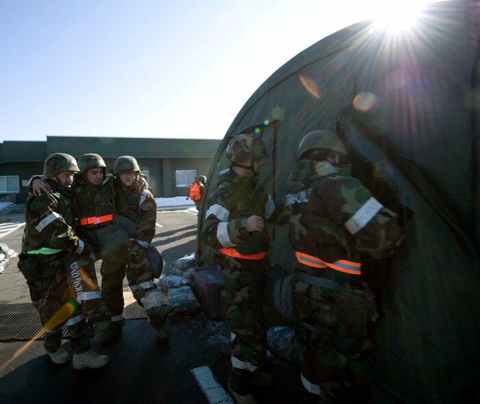Airmen help injured personnel during a simulated attack during an Operational Readiness Exercise at Misawa Air Base, Japan, Jan. 25. During the ORE, Airmen were given emergency scenarios and tested according to their response. (U.S. Air Force photo/Tech. Sgt. Russell McBride)