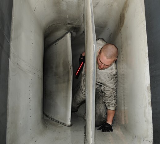 NELLIS AIR FORCE BASE, Nev. -- Senior Airman Jeffery Wood, 28th Aircraft Maintenance Squadron crew chief, crawls from the air intake of a B-1 Lancer from the 34th Bomb Squadron after performing a post-flight engine inlet inspection Jan. 26. Airmen Wood is deployed from Ellsworth Air Force Base, S.D., in support of Red Flag 11-2, a combined exercise that provides a realistic combat training environment to the U.S. and its allies. (U.S. Air Force photo/Staff Sgt. Benjamin Wilson)