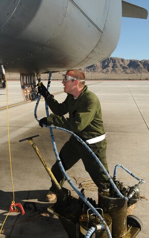 NELLIS AIR FORCE BASE, Nev. -- Airman 1st Class Mitch Sweeney, 28th Aircraft Maintenance Squadron crew chief, pumps fresh oil into a gearbox on a B-1 Lancer from the 34th Bomb Squadron after a mission Jan. 26. Airman Sweeney is deployed from Ellsworth Air Force Base, S.D., in support of Red Flag 11-2, a combined exercise that provides a realistic combat training environment to the U.S. and its allies. (U.S. Air Force photo/Staff Sgt. Benjamin Wilson)