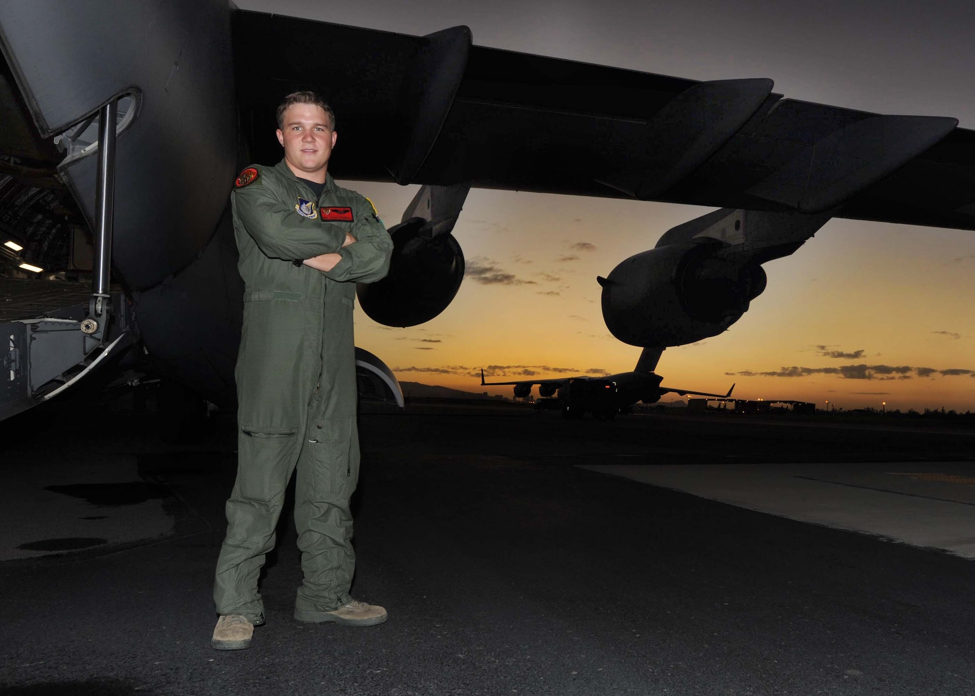 Senior Airman Colin Coleman, 535th Airlift Squadron Loadmaster, stands next to a C-17 on the 15th Wing flightline Jan. 25. Airman Coleman joined the Air Force in 2007 and has logged more than 500 flight hours since he became a loadmaster. (U.S. Air Force photo/Airman 1st Class Lauren Main)