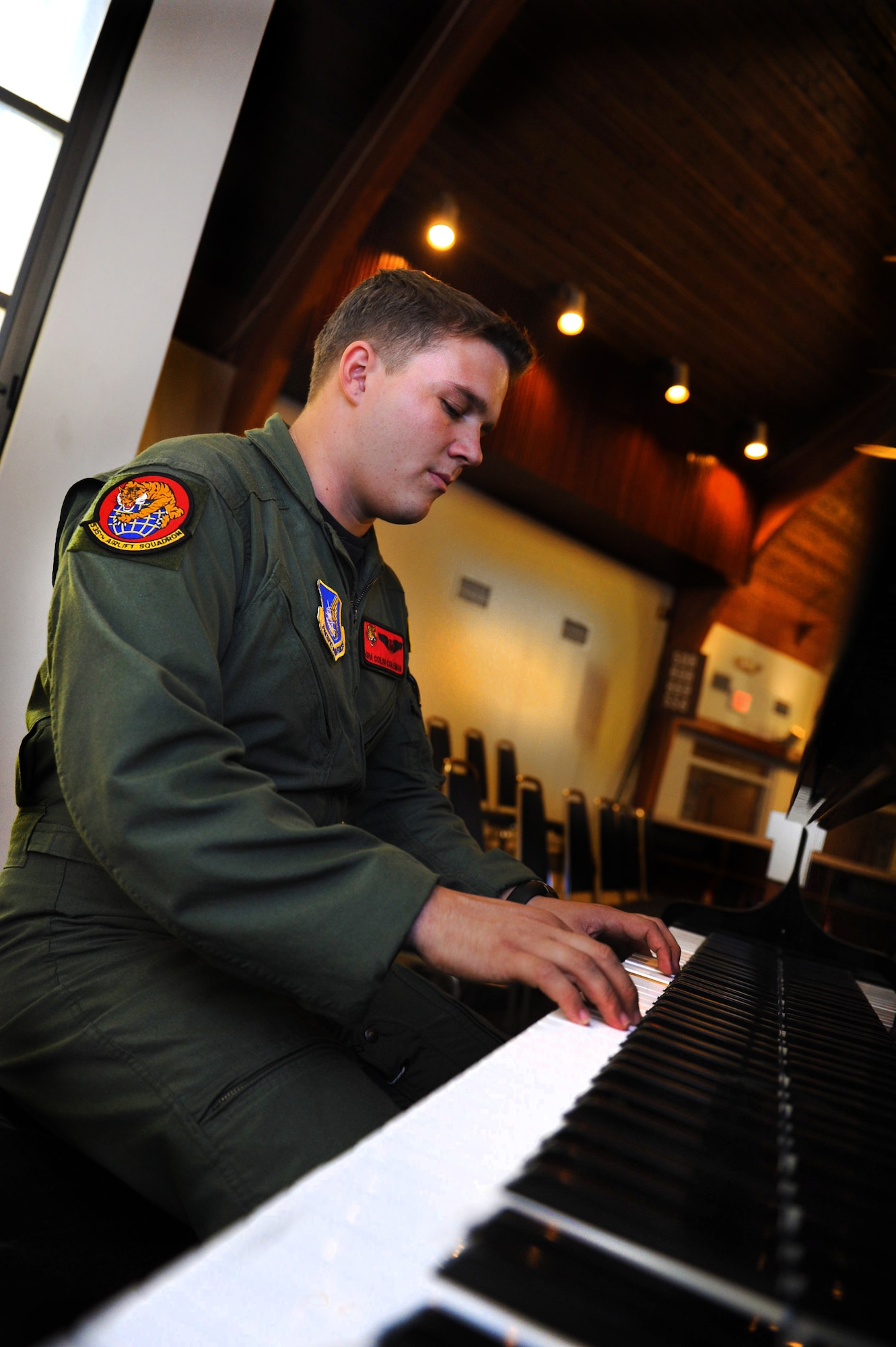 Senior Airman Colin Coleman, 535th Airlift Squadron loadmaster, plays the piano on Joint Base Pearl Harbor Hickam, Hawaii Jan. 24. Airman Coleman has been playing the piano for fifteen years. (U.S. Air Force photo/Airman 1st Class Lauren Main)