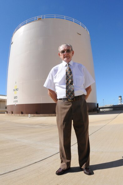 JOINT BASE PEARL HARBOR-HICKAM, Hawaii -- Mr. Stanley Zaucha, Pacific Air Forces Petroleum, Oils and Lubricants facilities manager, poses for a photograph in front of a fuel tank here Jan. 20. He's retiring in February 2011 after over 60 years of military and civil service fuels experience that has spanned six military campaigns including the Korean War and Operation Enduring Freedom. As a facilities manager here, Mr. Zaucha has been responsible for managing over 40 military construction projects valued in excess of $500 million. He has helped shaped the fuels infrastructure to meet the demands of today's state-of-the-art weapons systems. (U.S. Air Force photo/Tech. Sgt. Steve Lewis)