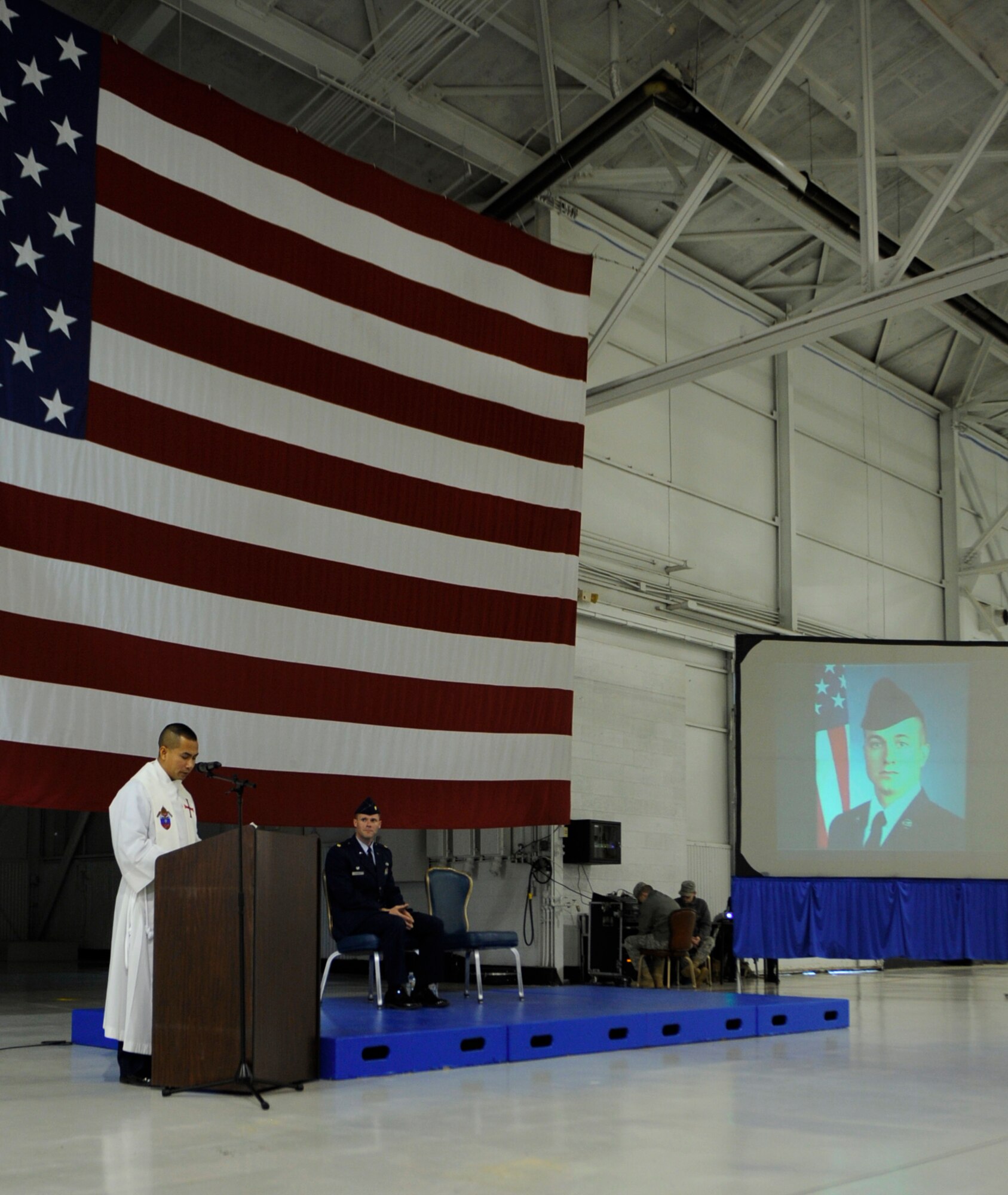 MOUNTAIN HOME AIR FORCE BASE, Idaho – MHAFB Chaplain (Capt.) Hoang Nguyen, reads an insert during the memorial service of Airman Jamie Burroughs Jan. 27 held in Hangar 1331. Airman Burroughs’ service was held in Hangar 1331, where Gunfighters gathered to celebrate the young Airman’s life.  (U.S. Air Force photo by Senior Airman Renishia Richardson)