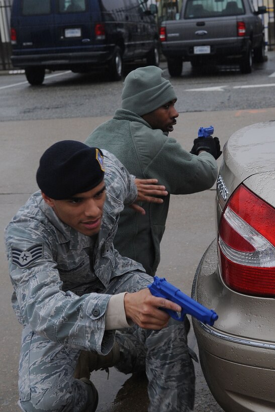 LANGLEY AIR FORCE BASE, Va. –Staff Sgt. Trayshawn Humphries, 633d Security Forces Squadron active shooter instructor, taps Staff Sgt. Brandon Kelly, response force patrolman, to advance into position during the bounding portion of security forces training Jan. 26. Security Forces consolidated a year-long on-the-job training into a month-long battery of required tasks to minimize the impact on day-to-day operations. (U.S. Air Force photo/Staff Sgt. Ashley Hawkins)(RELEASED)