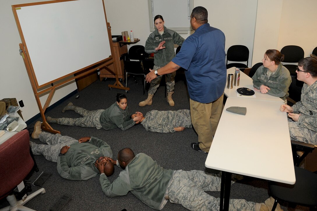 LANGLEY AIR FORCE BASE, Va. -- William Rupert, instructor with the 633d Security Forces Squadron, explains the use of the head tilt chin lift during self aid/buddy care Jan. 21.  Security Forces consolidated on-the-job training into a month-long battery of required tasks to minimize the impact on day-to-day operations. (U.S. Air Force photo/Staff Sgt. Ashley Hawkins)(RELEASED)