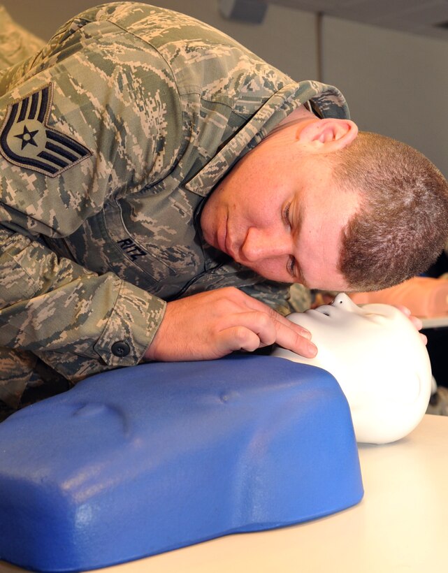 LANGLEY AIR FORCE BASE, Va. – Staff Sgt.  Frank Ritz, 633d Security Forces Squadron response force patrolman, looks, listens and feels for breathing and circulation on a training dummy during a CPR class Jan. 27.  The CPR certification class was part of the Squadron’s month-long training course, which included classes on integrated defense, self-aid and buddy care and active-shooter scenarios.  (U.S. Air Force photo/Staff Sgt. Logan Tuttle)(RELEASED)