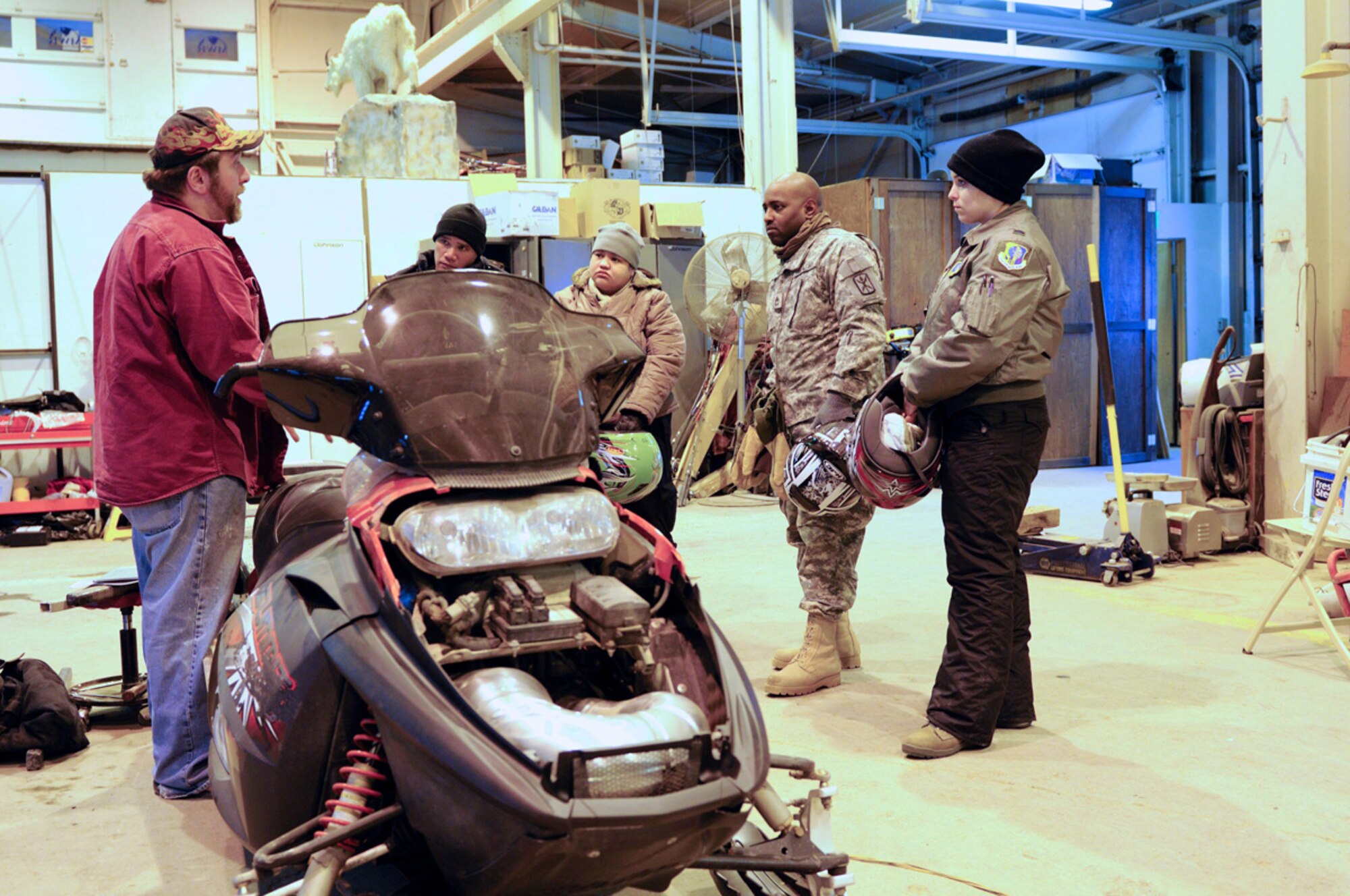 Nathan Dermer goes over controls of snowmachines before students move outside. (U.S.Air Force photo/Steve White)