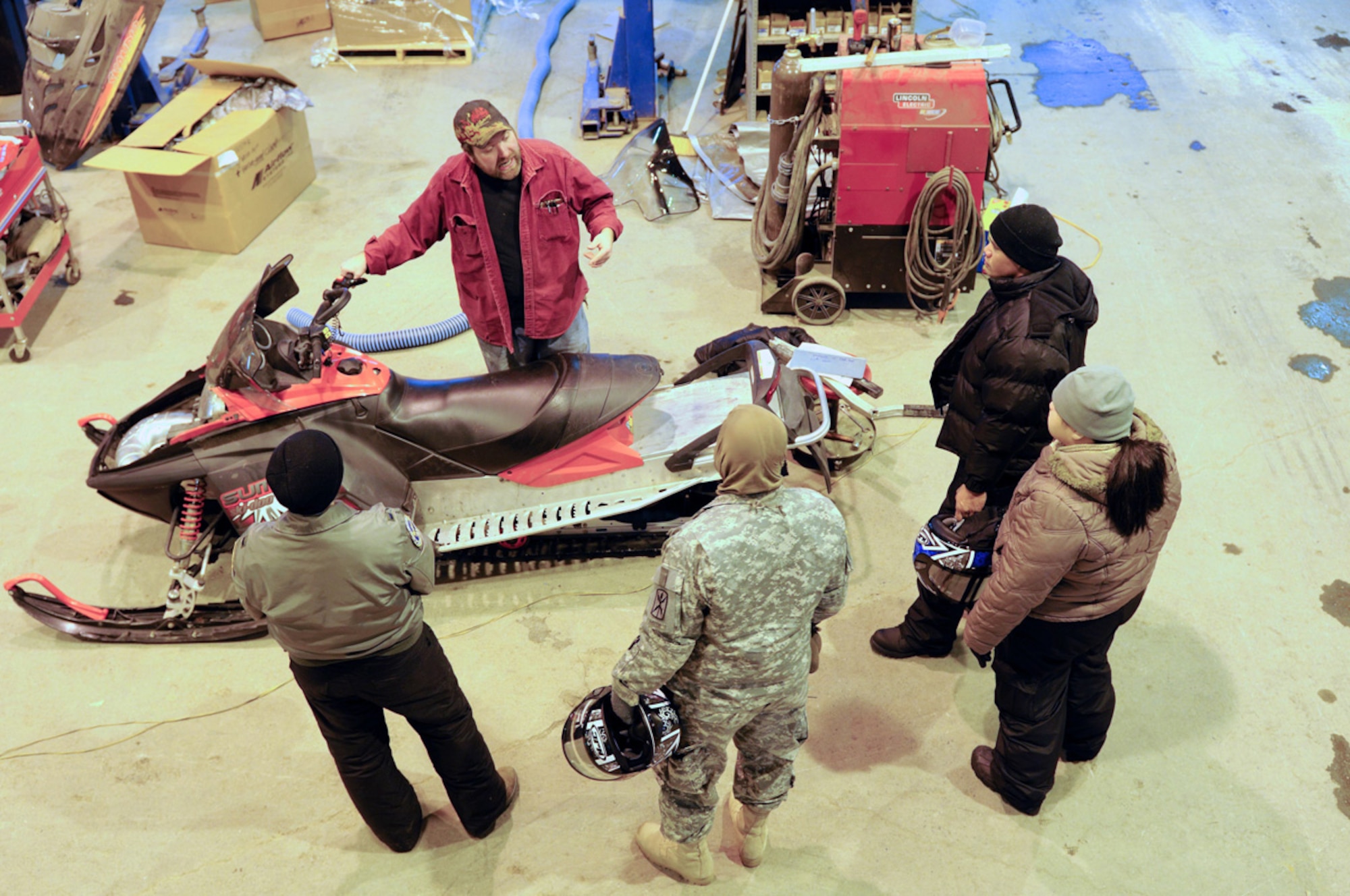 Nathan Dermer goes over controls of snowmachines before students move outside. (U.S. Air Force photo/Steve White)
