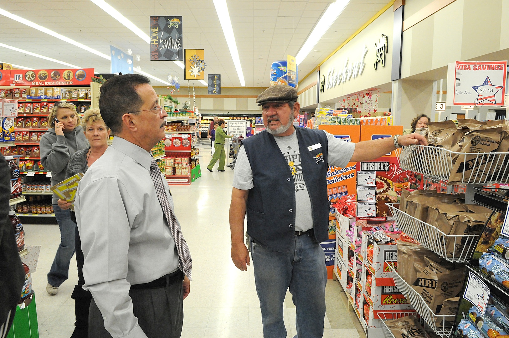 New commissary manager Juan Rodriguez, left, talks with associate Manuel Sanchez a he stocks the shelves at the commissary Jan. 21 at Randolph Air Force Base, Texas. (U.S. Air Force photo/David Terry)