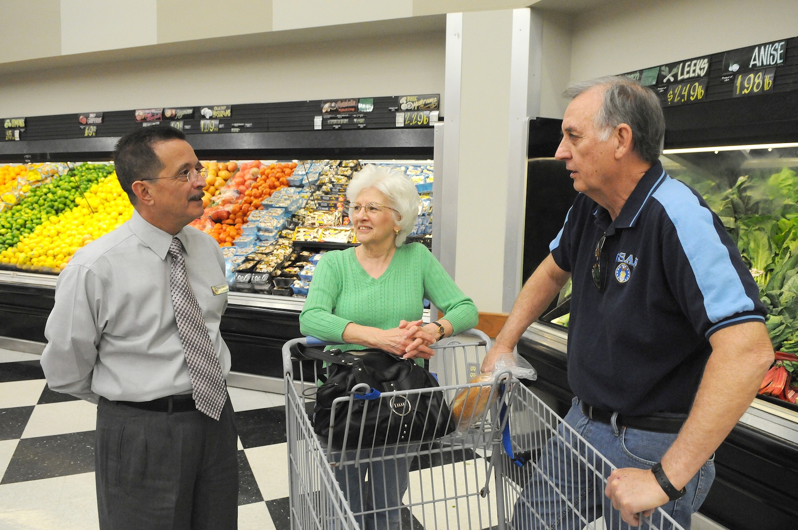 New commissary manager Juan Rodriguez greets customers Anne and Clifton Hedgepeth, retired master sergeant, as they begin their shopping in the produce department in the commissary at Randolph Air Force Base, Texas. (U.S. Air Force photo/David Terry)
