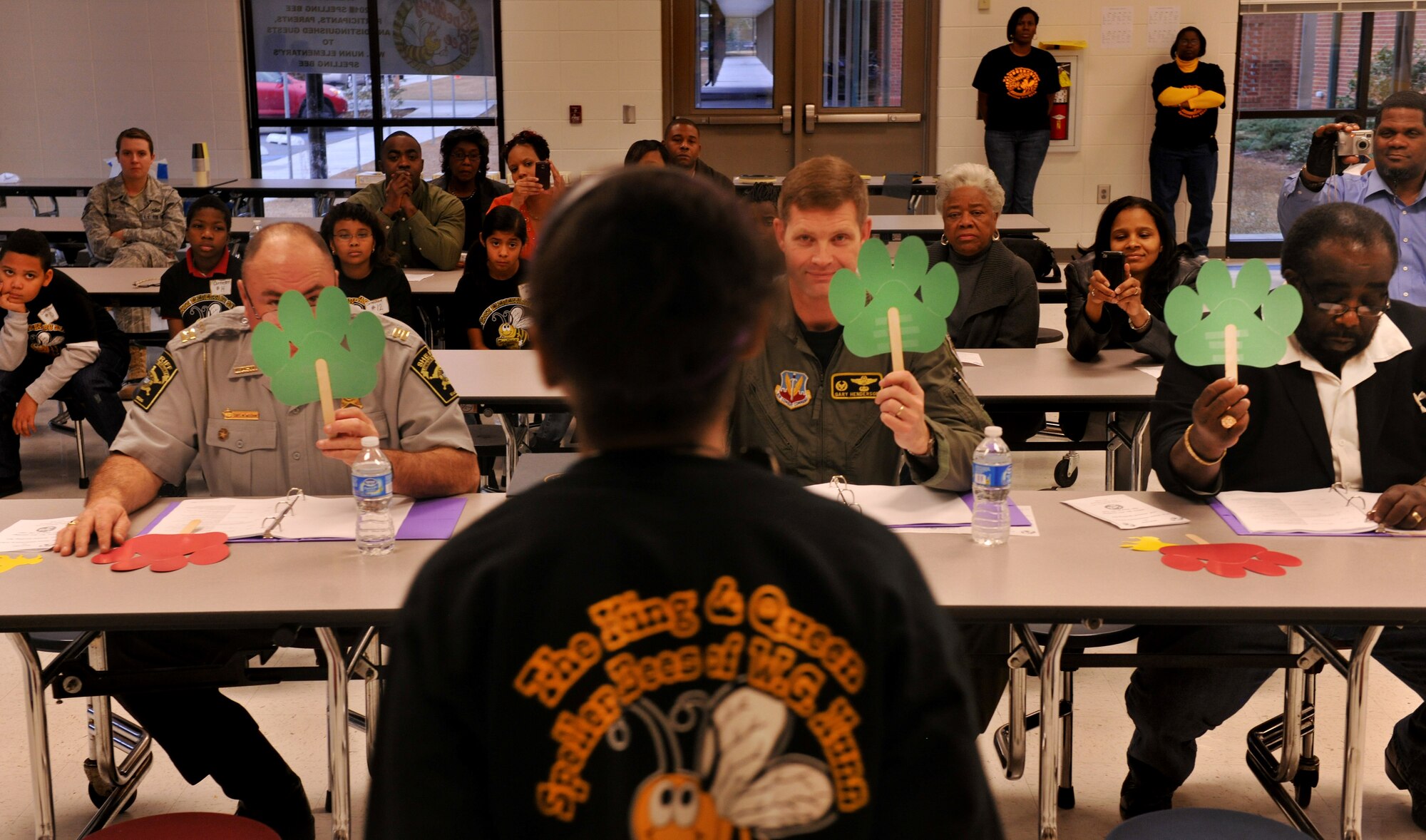 VALDOSTA, Ga.--  The judges for the King and Queen Spelling Bee at William Gaines Nunn Elementary School raise a green sign across the board for Ma’at Chastang, fifth-grade student from W.G. Nunn Elementary School, and the winner of the King and Queen Spelling Bee Jan. 21. Ma’at beat out 16 other students to gain first place. (U.S. Air Force photo/Airman 1st Class Joshua Green)(RELEASED)
