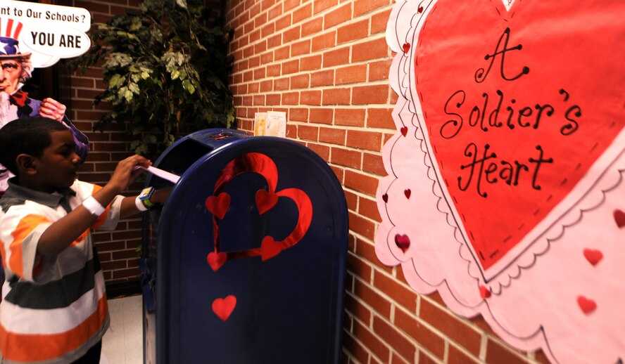 LAKELAND, Ga.-- A “Soldier’s Heart” poster sits on the wall above a mailbox as Noah Jenkins, Lanier County Primary School second-grade student, drops off his Valentine’s Day card Jan. 25. The school has nearly 600 students and each one made a card to send to a deployed service member. (U.S. Air Force photo/Airman 1st Class Benjamin Wiseman)(RELEASED)