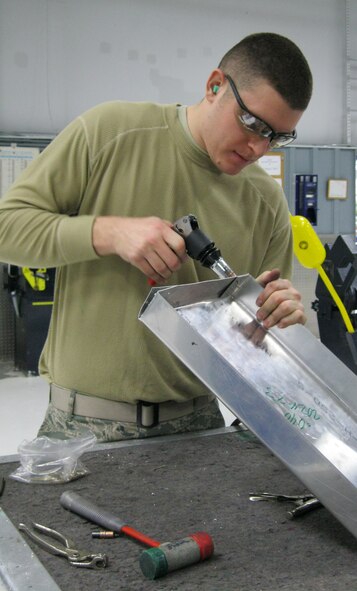 SEYMOUR JOHNSON AIR FORCE BASE, N.C. – Airman 1st Class Andrew Parlogean assembles a drip pan here Jan. 25, 2011. The drip pan will be placed under a piece of equipment in the 4th Equipment Maintenance Squadron aircraft structural maintenance shop to collect oil. Airman Parlogean, 4th Equipment Maintenance Squadron aircraft structural maintenance journeyman, hails from Decatur, Texas. (U.S. Air Force photo/Tech. Sgt. Tammie Moore) (RELEASED)