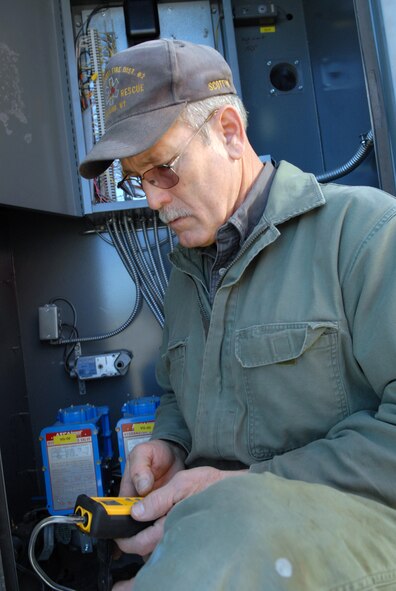 Chuck Scottini, 90th Civil Engineer Squadron plumber, uses a manometer to measure the pressure in the gas line after he replaced a gas regulator here Jan. 26. This particular regulator controls the flow of gas in to the paint booth of the missile maintenance facility. (U.S. Air Force photo by R.J. Oriez)