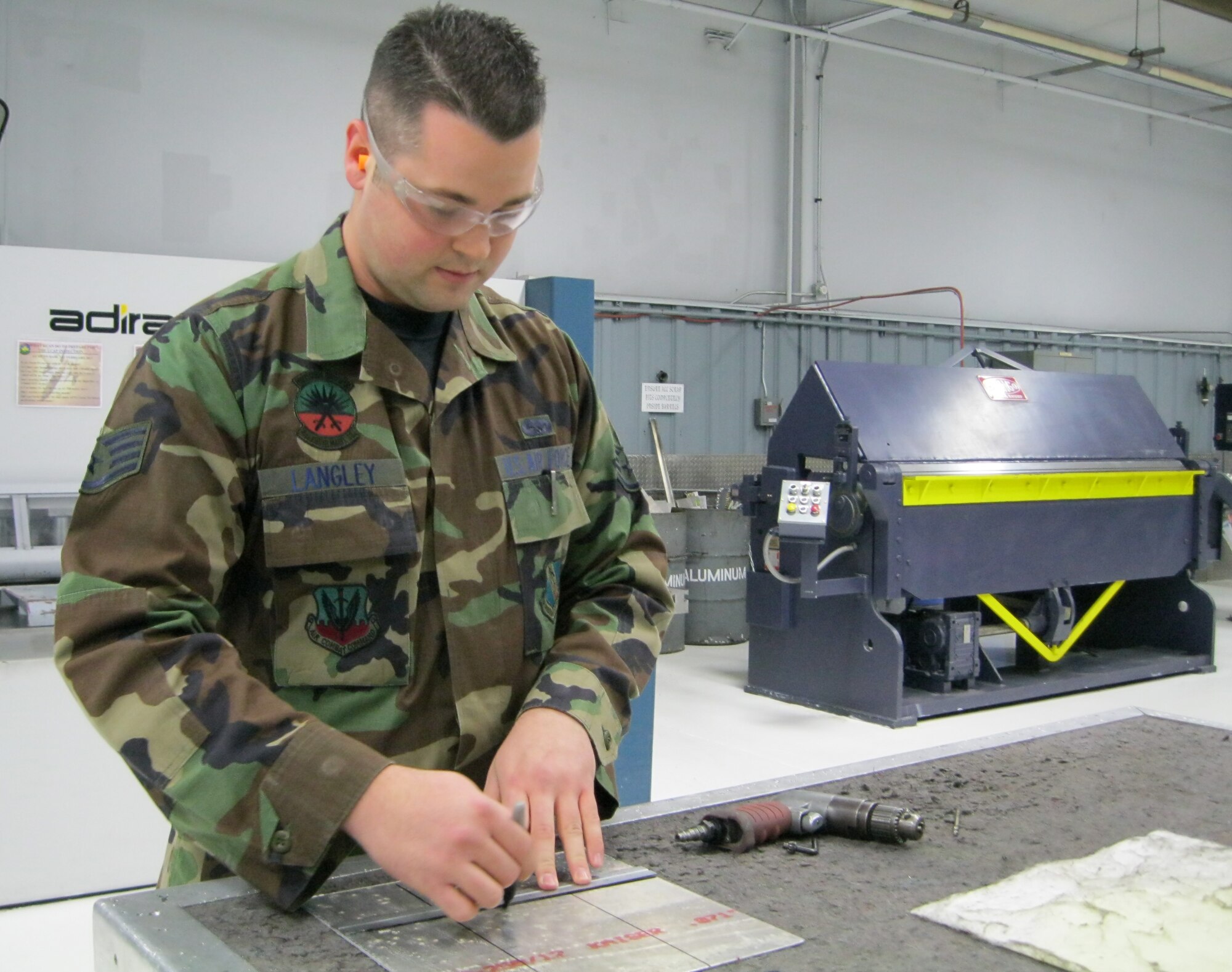 SEYMOUR JOHNSON AIR FORCE BASE, N.C. – Staff Sgt. Samuel Langley annotates measurements on a piece of sheet metal before he begins drilling it here Jan. 25, 2011. Sergeant Langley, 4th Equipment Maintenance Squadron aircraft structural maintenance craftsman and unit training manager, hails from Texarkana, Texas. (U.S. Air Force photo/Tech. Sgt. Tammie Moore) (RELEASED)