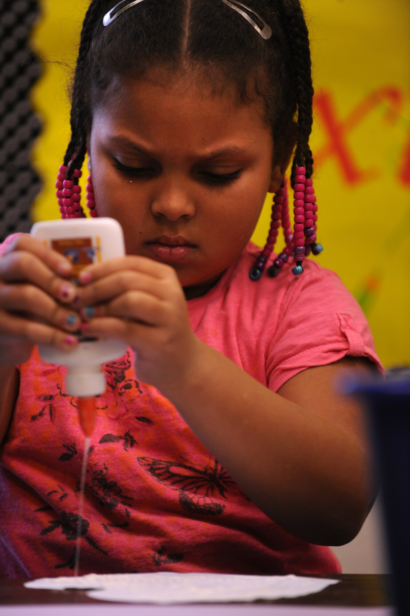 LAKELAND, Ga.-- Dasia Dent, Lanier County Primary School second-grade student, applies glue to the back of her Valentine’s Day card Jan. 25. Students from the school used crayons, glue and other decorating material to make each Valentine’s Day card unique.  (U.S. Air Force photo/Airman 1st Class Benjamin Wiseman)(RELEASED)