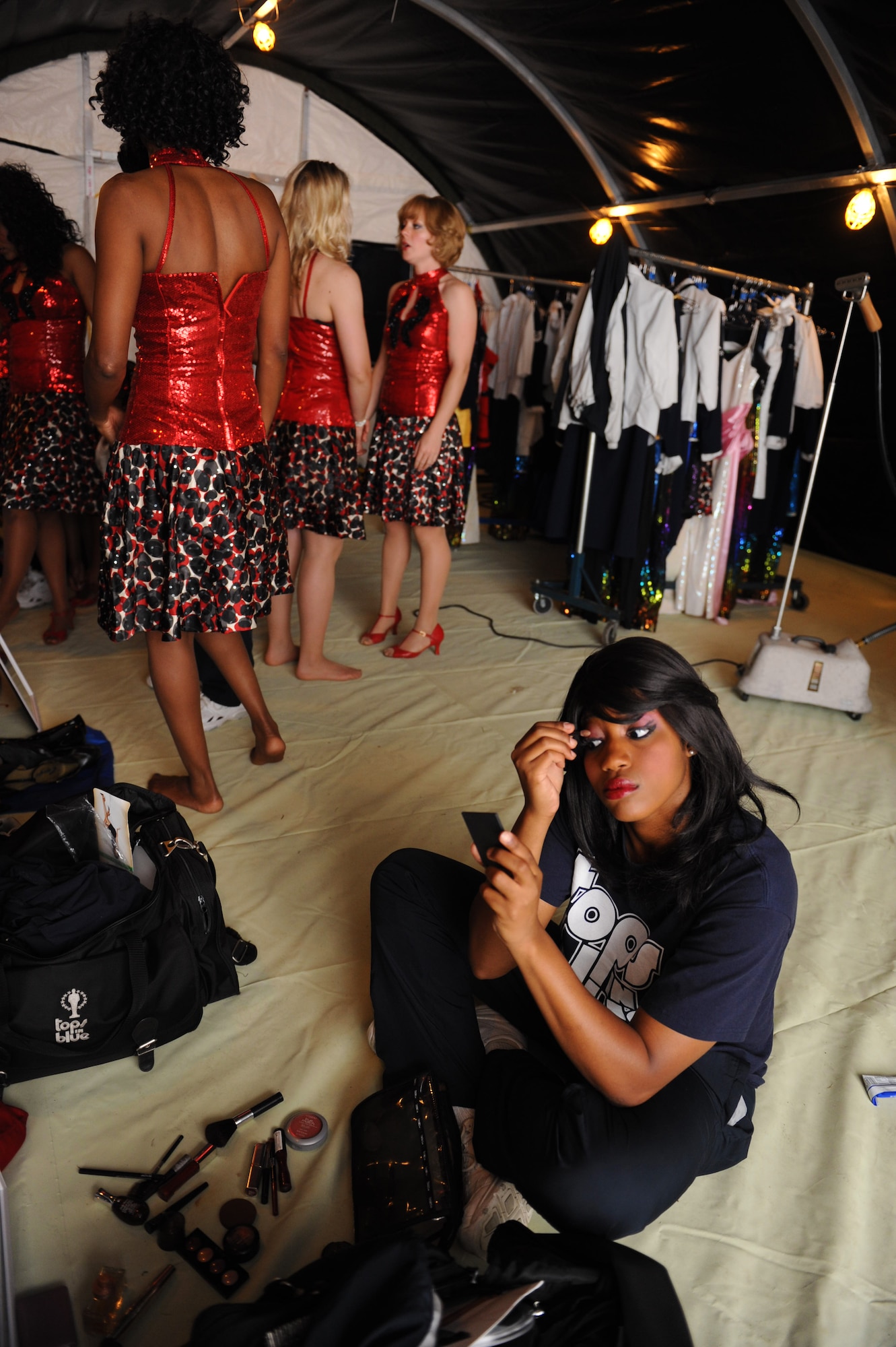 Entertainers from Tops in Blue get ready for their performance at Freedom Tower on Joint Base Pearl Harbor-Hickam, Hawaii, Jan 26. Major Al Reilly created the Air Force Worldwide Talent Contest in 1953 to recognize talented Airmen in various categories ranging from comedy, drama, vocals and musical instruments. During the first year, Tops in Blue performed 230 shows in 235 days. The same breakneck pace continues today. (U.S. Air Force Photo/Airman 1st Class Lauren Main)