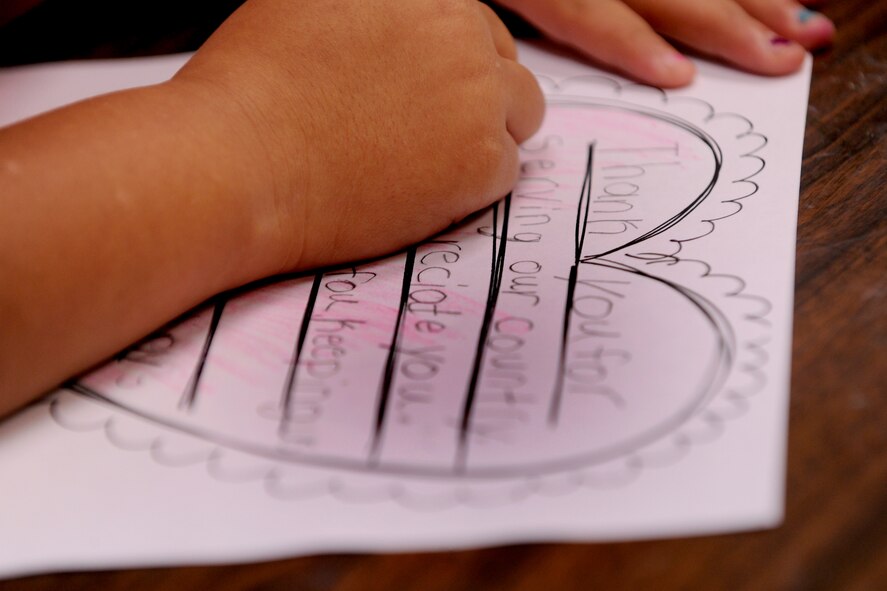 LAKELAND, Ga.-- A student from Lanier County Primary School colors a Valentine’s Day card that will be sent to service members deployed to Afghanistan Jan. 25. The school plans to gather all the cards and mail them so deployed military members will receive them  by Valentine’s Day. (U.S. Air Force photo/Airman 1st Class Benjamin Wiseman)(RELEASED)