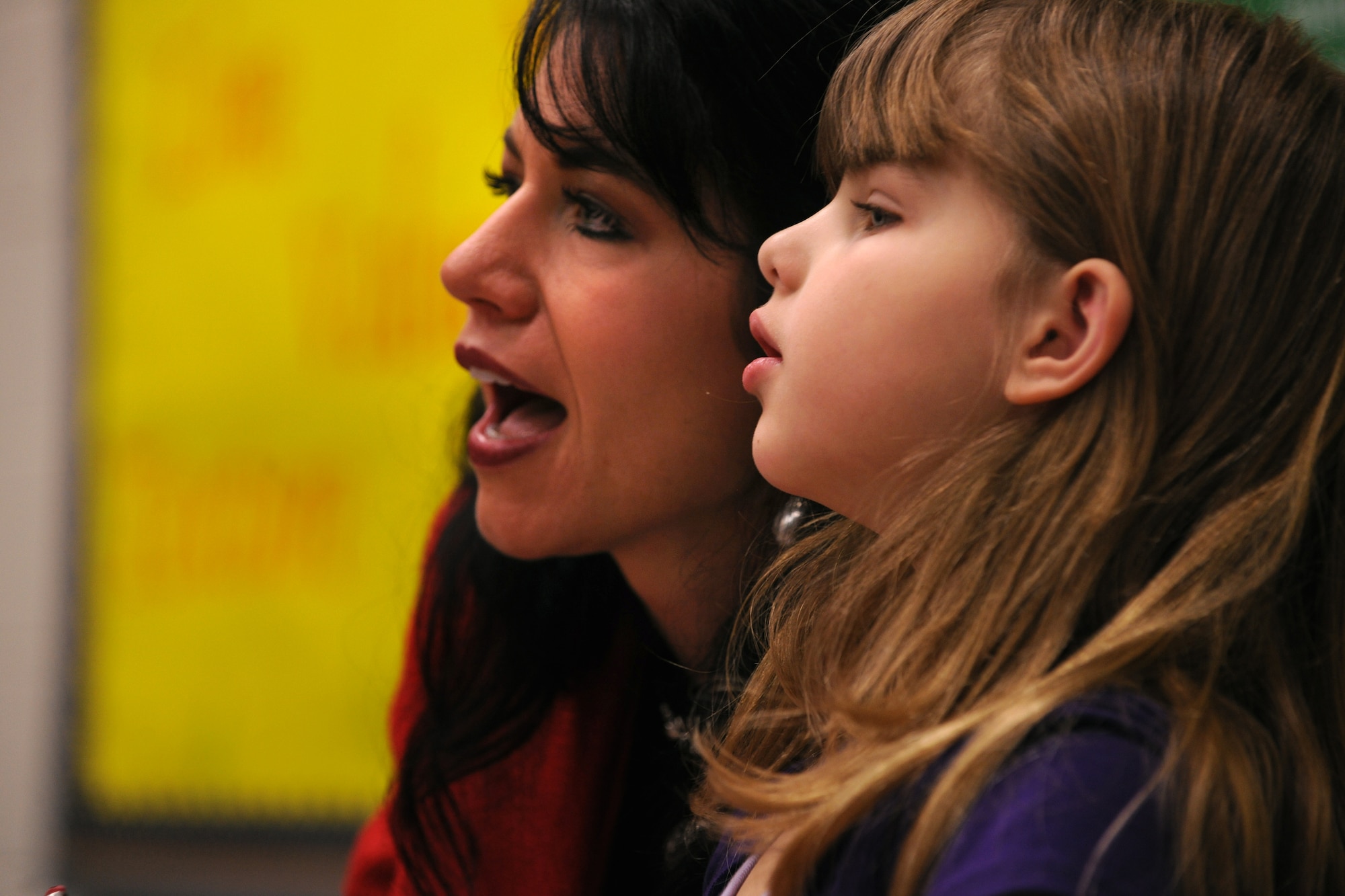 LAKELAND, Ga.-- Cindy Lyons, Lanier County Primary School art teacher, assists Isabel Land, LCPS second-grade student, in writing her Valentine’s Day card Jan. 25. Isabel said she liked making cards because her dad is in the military. (U.S. Air Force photo/Airman 1st Class Benjamin Wiseman)(RELEASED)