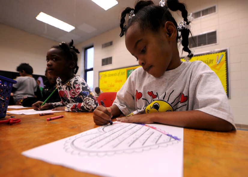 LAKELAND, Ga.-- T’nyia Spivey, Lanier County Primary school second-grade student, prepares a Valentine’s Day card Jan. 25 for service members deployed to Afghanistan. Students from the school colored and wrote “Thank you” messages on the cards before mailing them.  (U.S. Air Force photo/Airman 1st Class Benjamin Wiseman)(RELEASED)