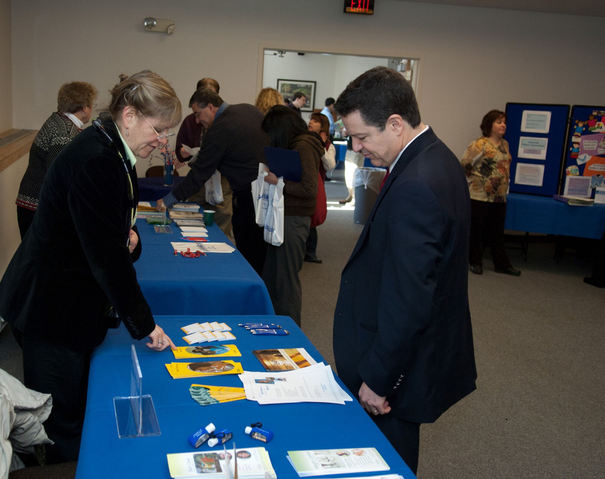 HANSCOM AIR FORCE BASE, Mass. – Ina Bachman (left) speaks with Anthony Golante about the Employee Assistance Program during the information fair at the Installation Commander’s Welcome on Jan. 24. Agencies from across the base attend the information fair to distribute information about their services to newcomers. (U.S. Air Force photo by Rick Berry)