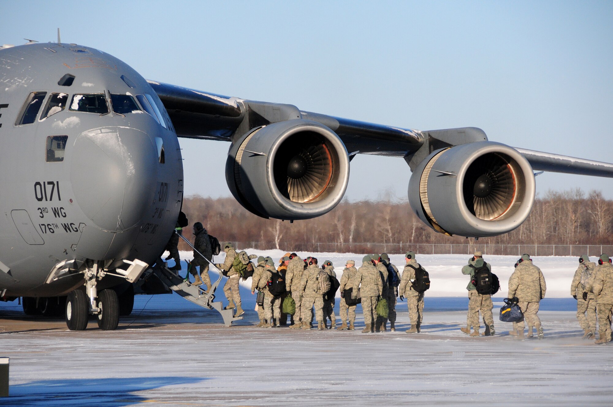 Service members from the Minnesota Air National Guard's 148th Fighter Wing board a C-17 Globemaster III Jan. 22, 2011, in Duluth, Minn. The C-17 is bound for training exercise Combat Archer, the first operational test of newly upgraded F-16 Fighting Falcons at Tyndall Air Force Base, Fla. (U.S. Air Force photo/Staff Sgt. Donald Acton)