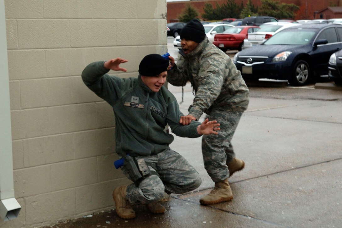 LANGLEY AIR FORCE BASE, Va. – Staff Sgt. Marquin King, 633d Security Forces Squadron active shooter instructor, detains Senior Airman Patrick McCoy, 633 SFS Combat Arms Training and Maintenance instructor, during the L-shaped formation training Jan. 26. Security forces use hands-on training to prepare Airmen for on-the-job scenarios. (U.S. Air Force photo/Airman 1st Class Racheal Watson)(RELEASED)