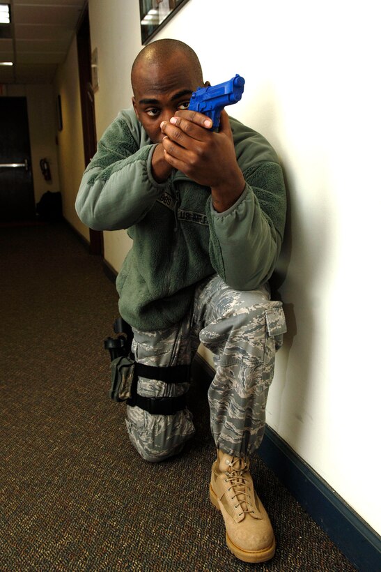 LANGLEY AIR FORCE BASE, Va. – Staff Sgt. Christopher Cobbs, 633d Security Forces Squadron emergency communication controller, secures the hallway during a training exercise, while team members search rooms Jan. 26. Security forces use hands-on training to prepare Airmen for clearing buildings. (U.S. Air Force photo/Airman 1st Class Racheal Watson)(RELEASED)