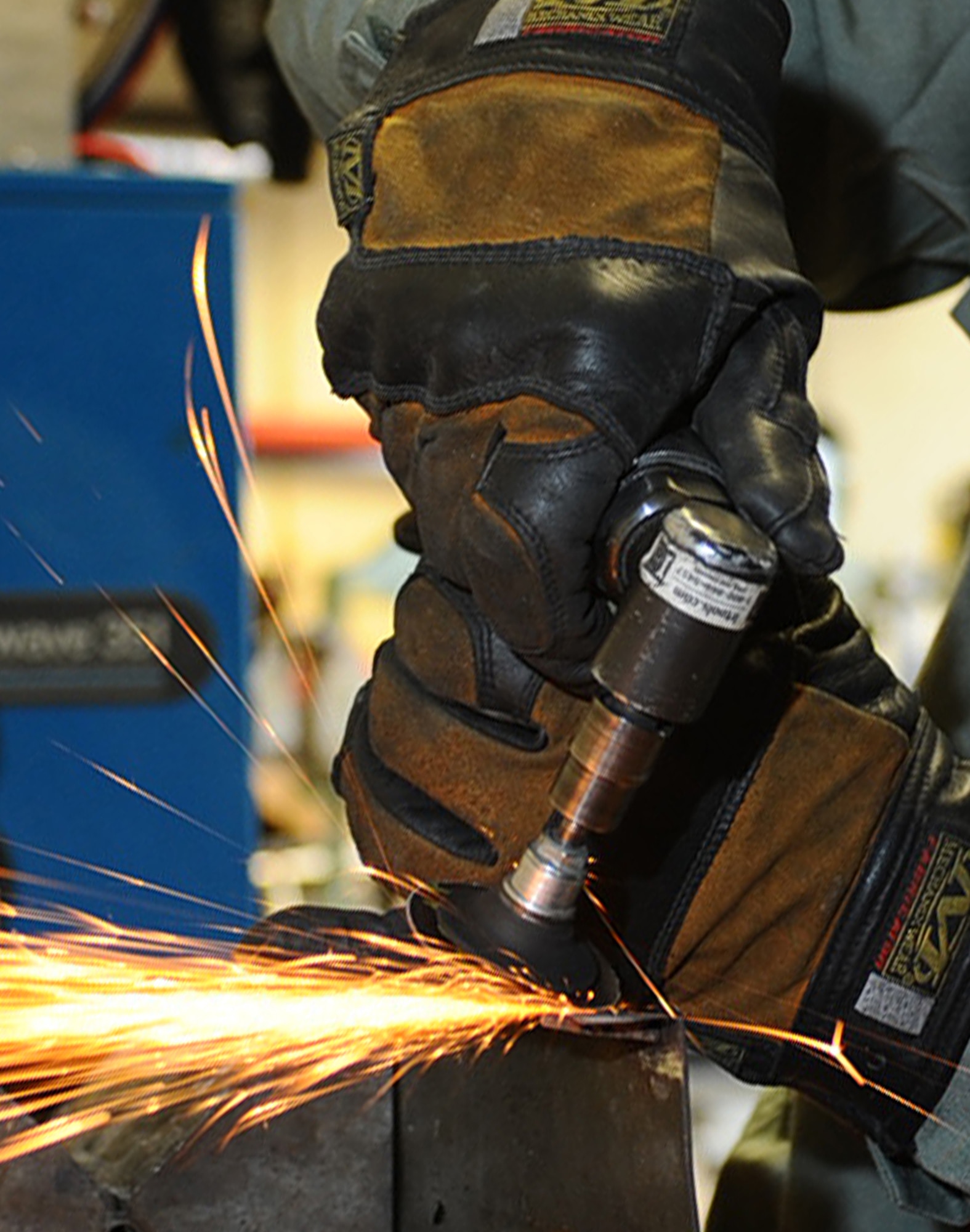 Airman 1st Class Webb Travis, 28th Maintenance Squadron aircraft metals technology technician, grinds down a weld on a bomb loader panel at Ellsworth Air Force Base, S.D., Jan. 26, 2011. The Metals Technology Shop fabricates a variety of parts for a wide range of equipment on base. (U.S. Air Force photo/Senior Airman Kasey Close)